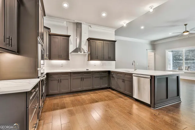 a kitchen with stainless steel appliances kitchen island granite countertop a sink and cabinets