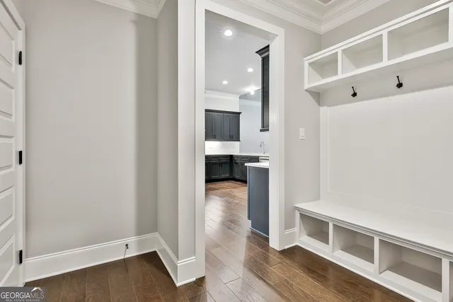 a view of a hallway view with wooden floor and staircase