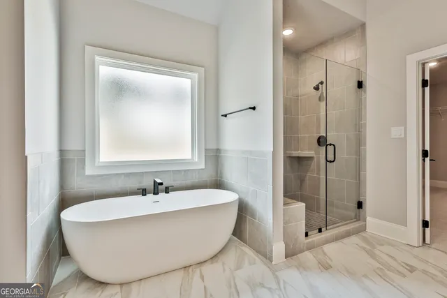 a bathroom with a bathtub and shower
