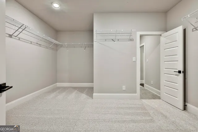 a spacious bathroom with double sink and mirror