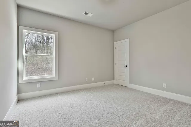 a view of empty room with a fireplace