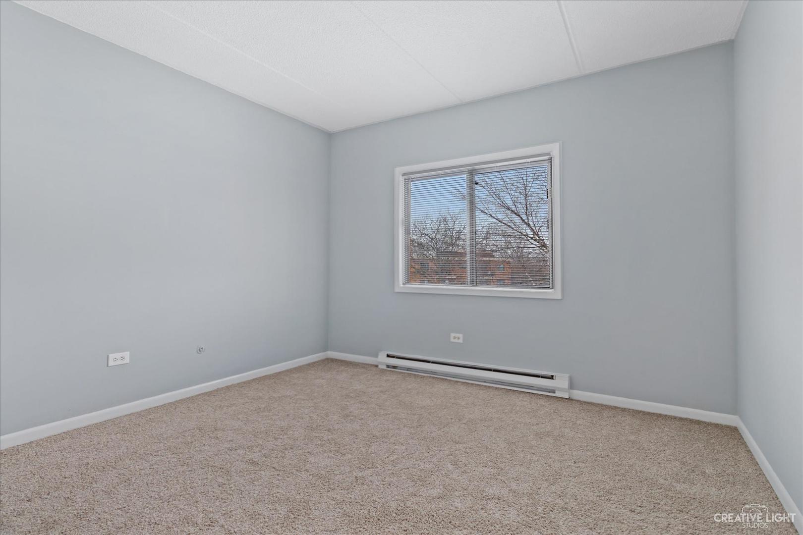 962 North Rohlwing Road, Unit 201B Addison, IL 60101 - Photo 17 of 18 an empty room with a window