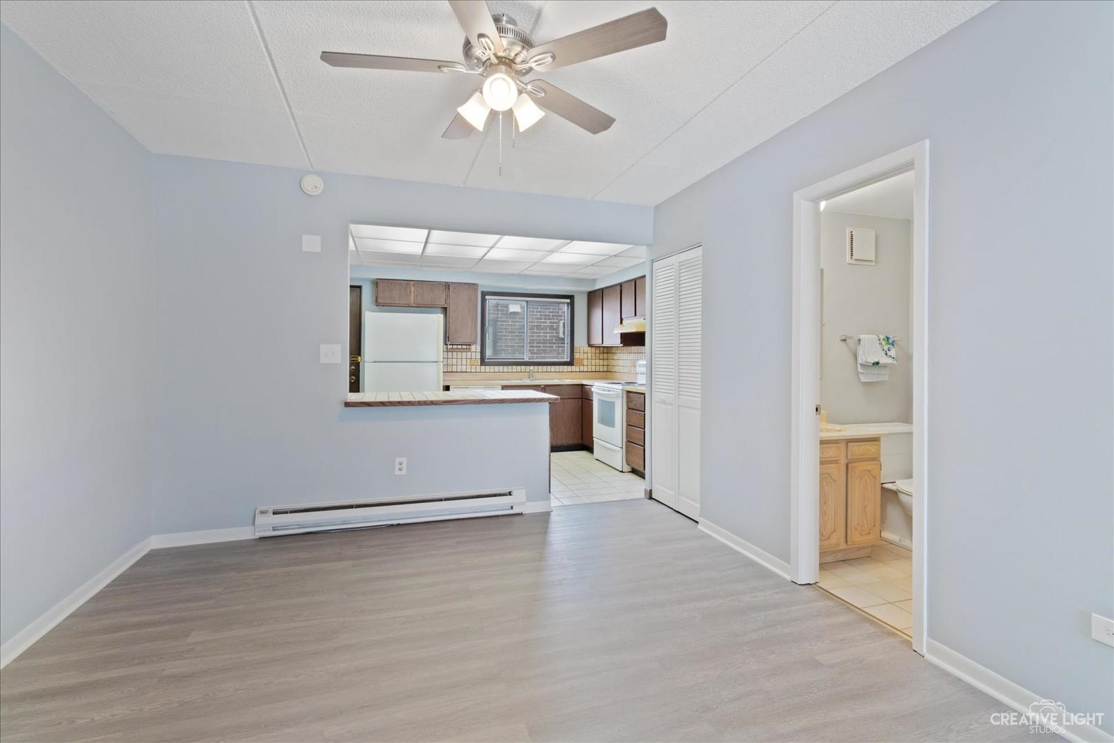 962 North Rohlwing Road, Unit 201B Addison, IL 60101 - Photo 7 of 18 a view of a kitchen with a sink and a kitchen