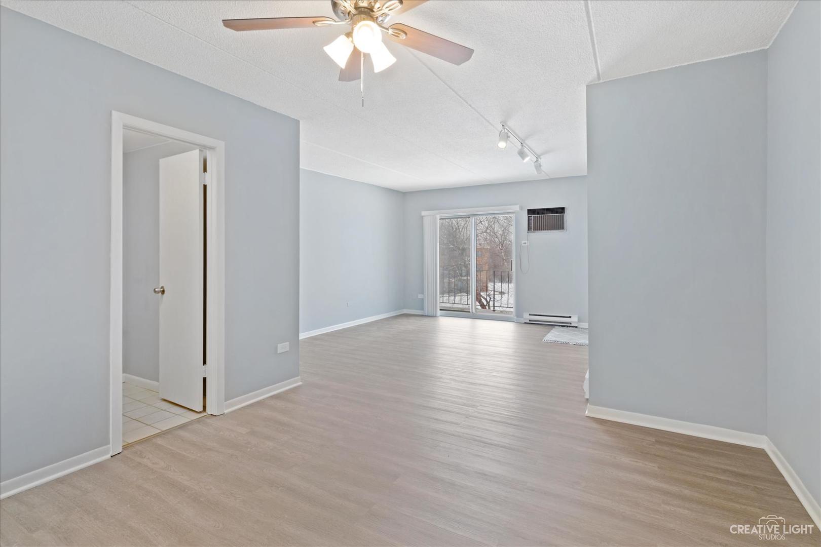 962 North Rohlwing Road, Unit 201B Addison, IL 60101 - Photo 8 of 18 wooden floor in an empty room with a window