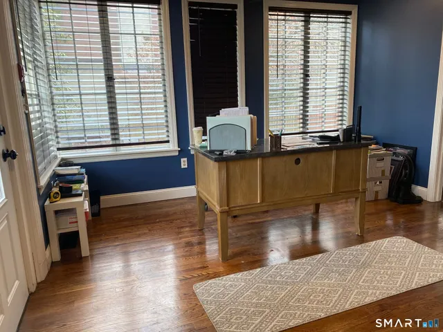a living room with furniture window and wooden floor