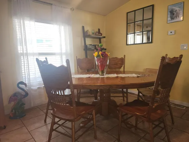 a view of a dining room with furniture and window