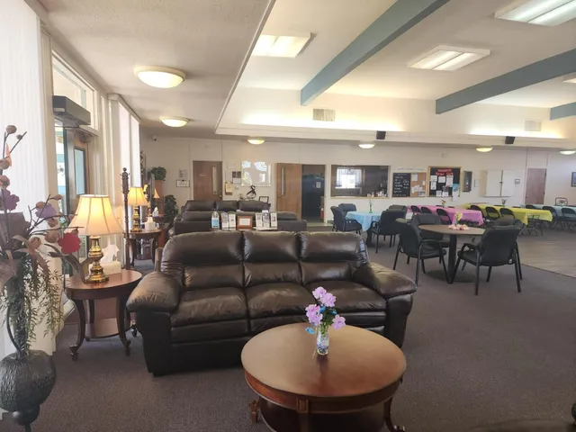 a living room with furniture kitchen view and a chandelier