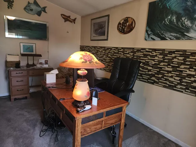 a room with furniture a flat screen tv and lamp
