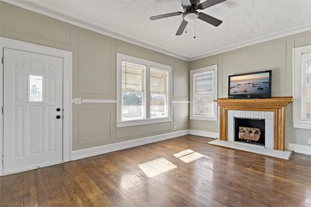 a view of an empty room with window and fire place