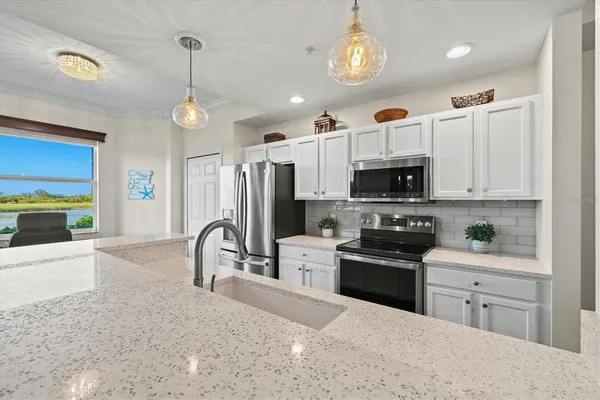a living room with furniture a flat screen tv and a floor to ceiling window