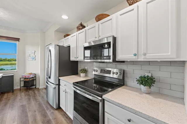 a bed sitting in a bedroom chandelier and dresser