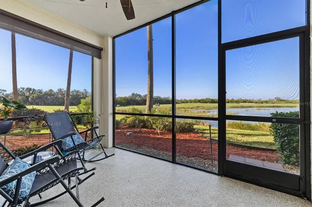 a view of a swimming pool with lawn chairs under an umbrella