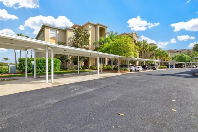 a kitchen with stainless steel appliances kitchen island granite countertop a refrigerator a oven and a sink with large countertops