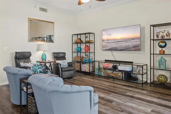 a living room with furniture and a book shelf
