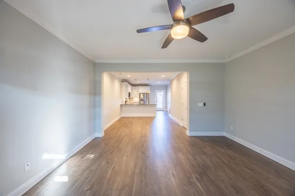 a view of a hallway with wooden floor