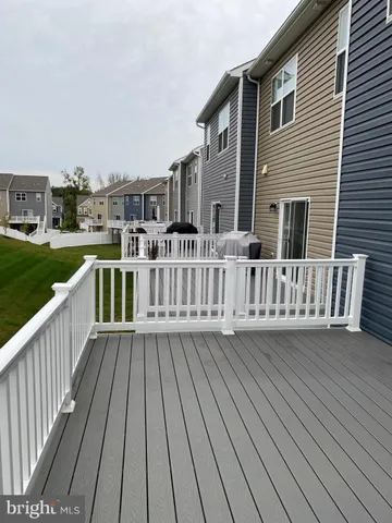 a view of a deck with wooden floor and fence