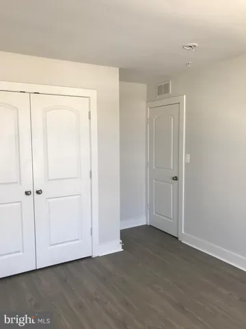 an empty room with wooden floor