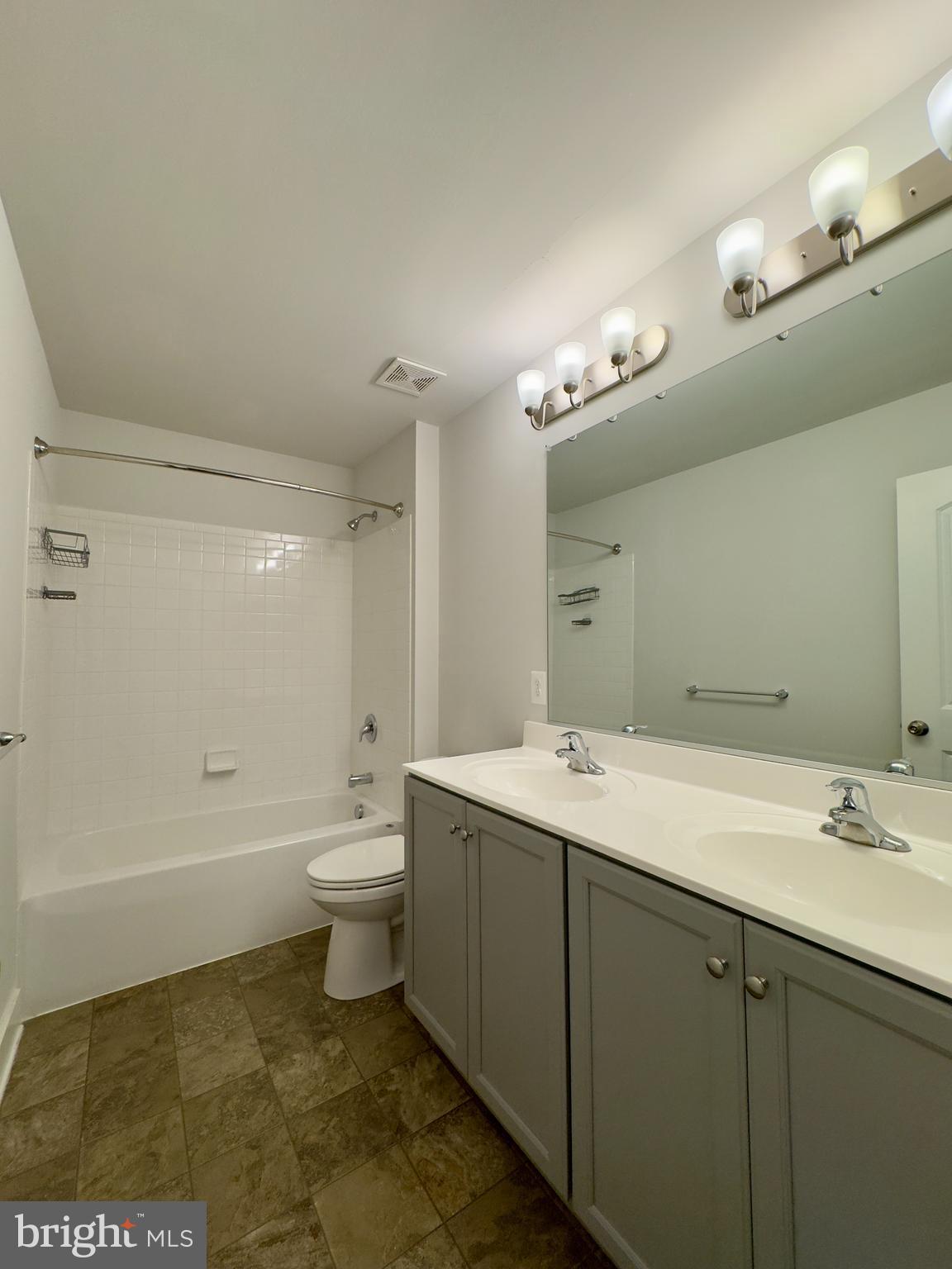 2775 Town View Circle New Windsor, MD 21776 - Photo 28 of 29 a bathroom with a double vanity sink a toilet and a mirror