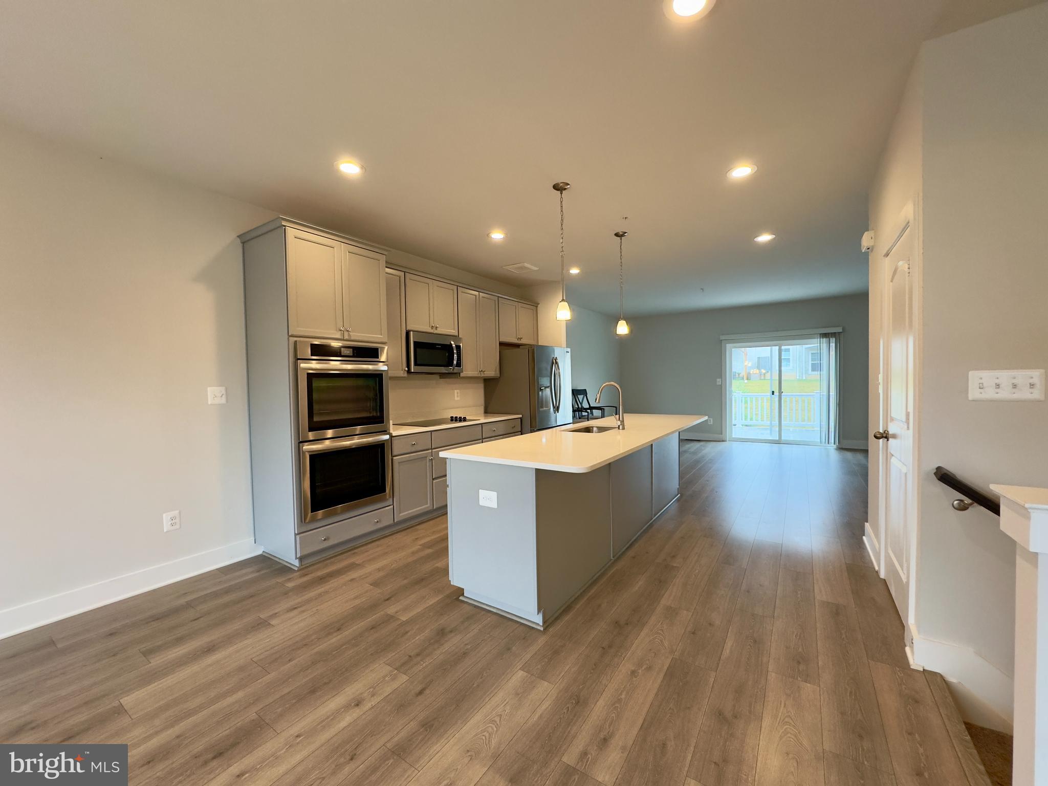 2775 Town View Circle New Windsor, MD 21776 - Photo 4 of 29 a large kitchen with stainless steel appliances kitchen island a large counter top and a wooden floors