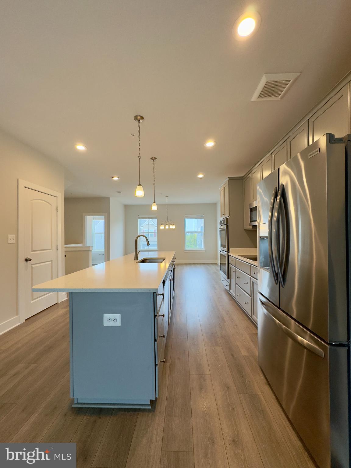 2775 Town View Circle New Windsor, MD 21776 - Photo 5 of 29 a kitchen with stainless steel appliances granite countertop a refrigerator a stove a sink dishwasher and a refrigerator with wooden floor