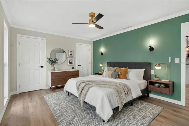 a bedroom with a large bed and a chandelier