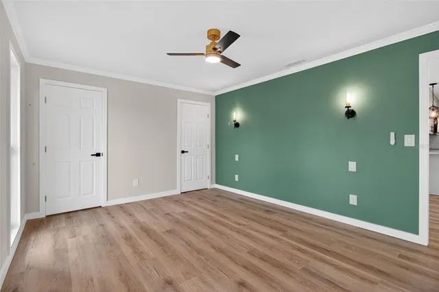 a view of empty room with wooden floor