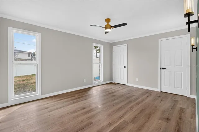 a view of an empty room with wooden floor