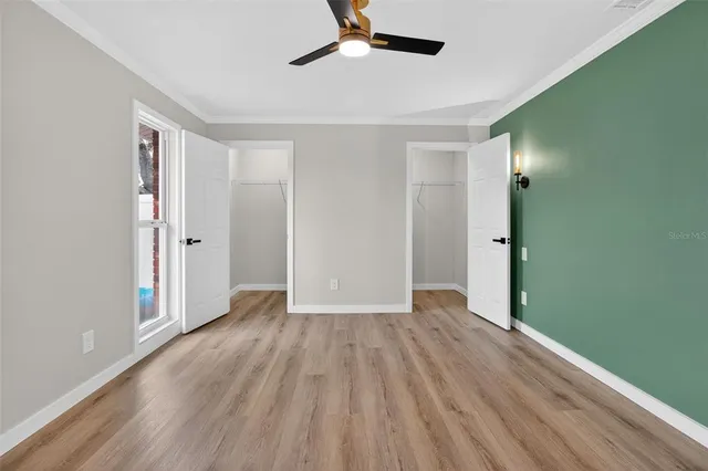 a view of an empty room with wooden floor