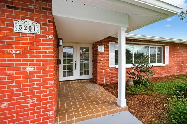 a view of a brick house with a large window