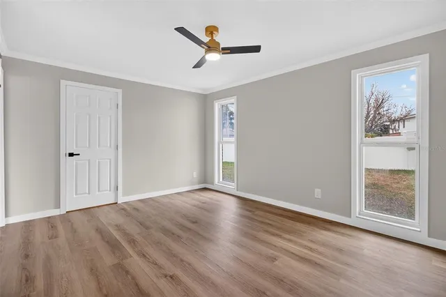 wooden floor in an empty room with a window