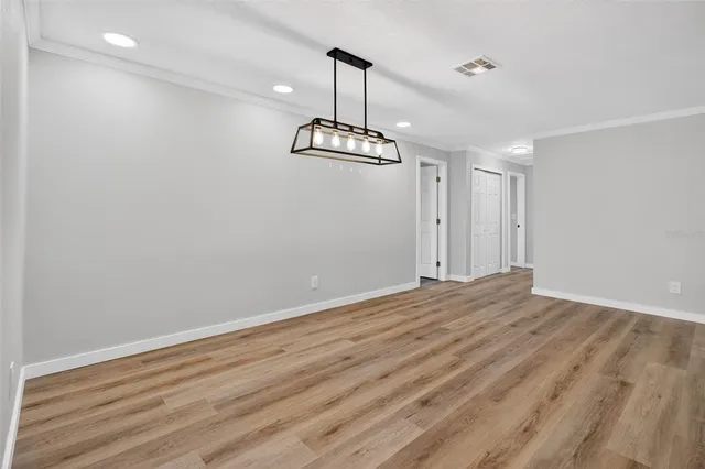 a view of a room with wooden floor and window