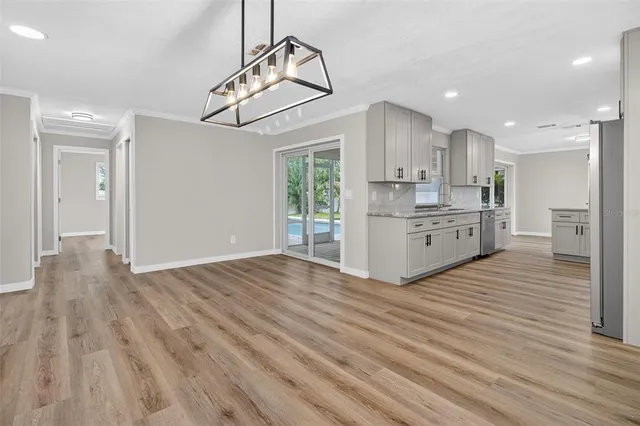 a view of a kitchen with a sink and wooden floor