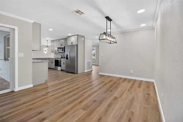 a view of a kitchen with a refrigerator a sink and dishwasher a refrigerator with wooden floor