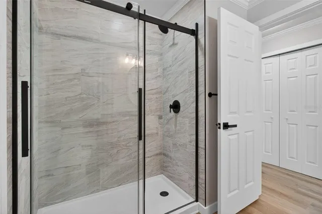 a bathroom with a glass shower door