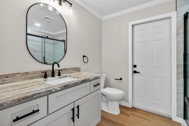 a bathroom with a toilet a sink and a mirror