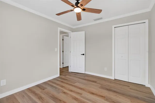 a view of an empty room with wooden floor
