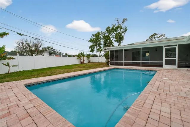 a view of a swimming pool with a yard