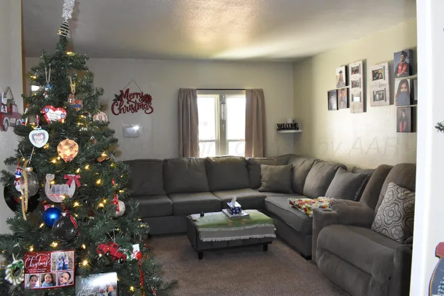 a living room with furniture and a potted plant