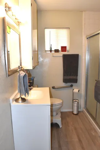 a bathroom with a toilet sink and mirror