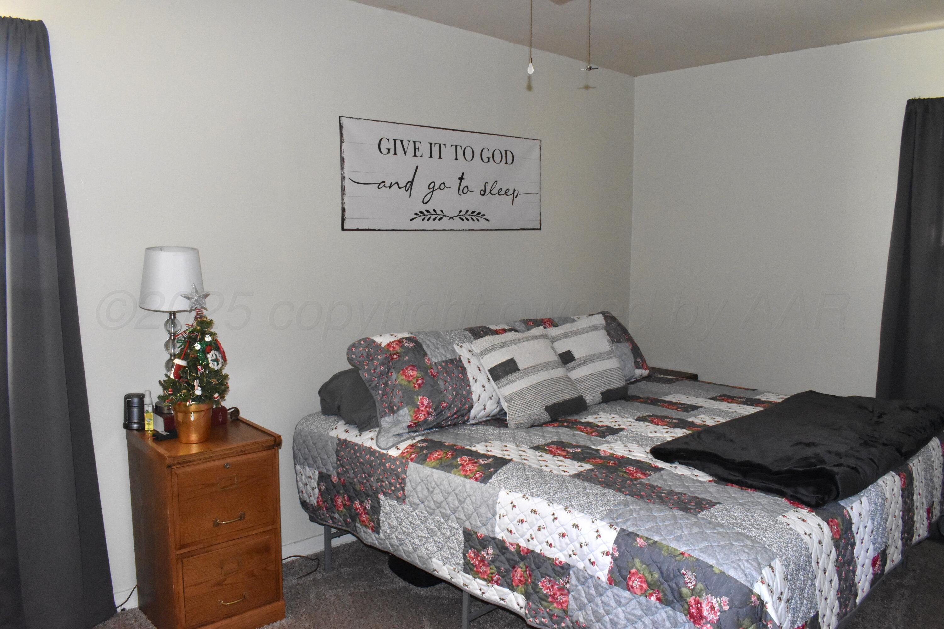 1919 Cherry Street Amarillo, TX 79106 - Photo 16 of 19 a bedroom with a bed and wooden floor