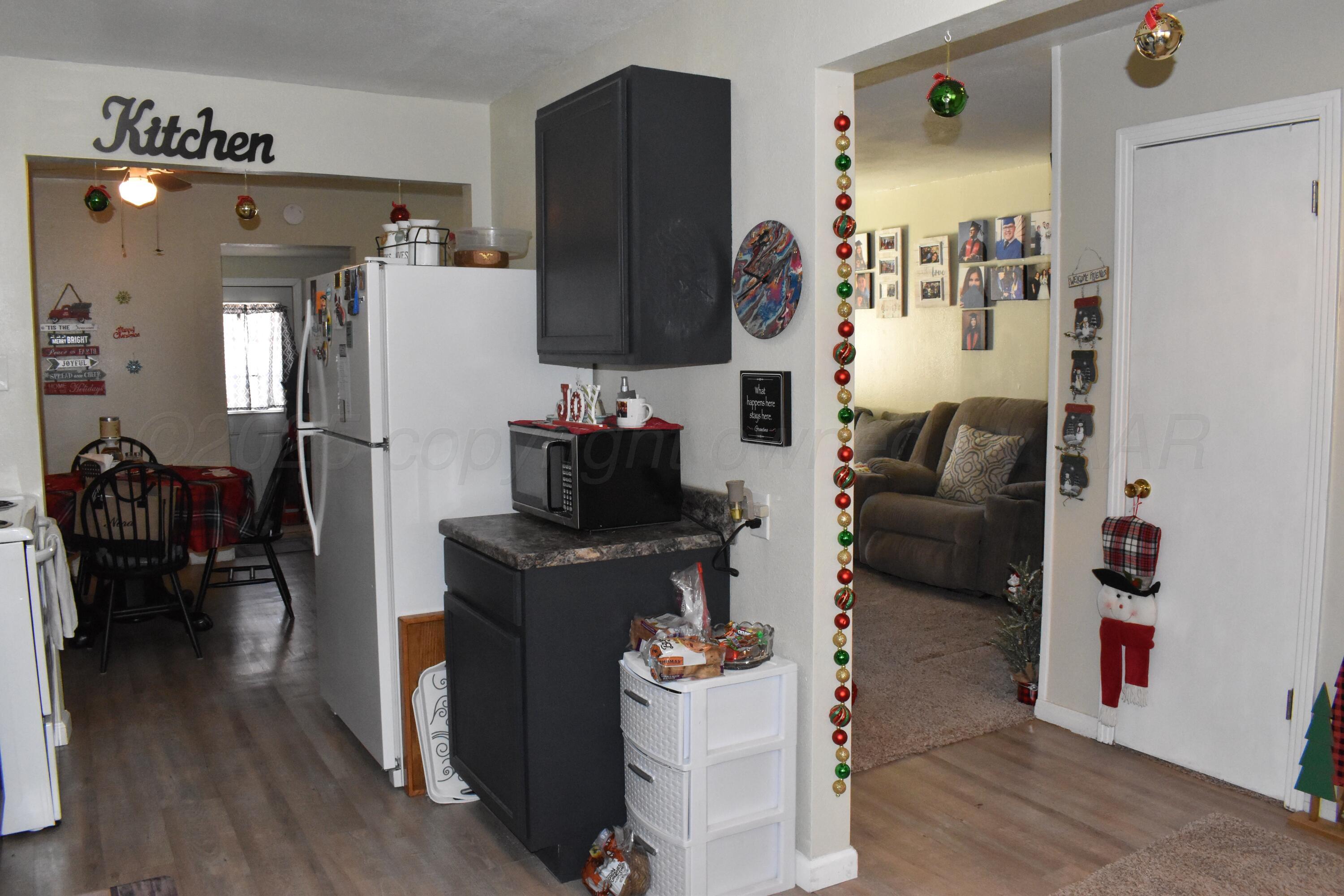 1919 Cherry Street Amarillo, TX 79106 - Photo 10 of 19 a living room with furniture a flat screen tv and a fireplace
