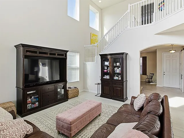 a kitchen with stainless steel appliances granite countertop a refrigerator a stove a sink and a microwave