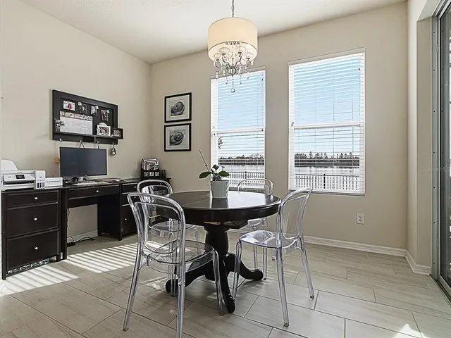 a roof deck with table and chairs a barbeque with wooden floor
