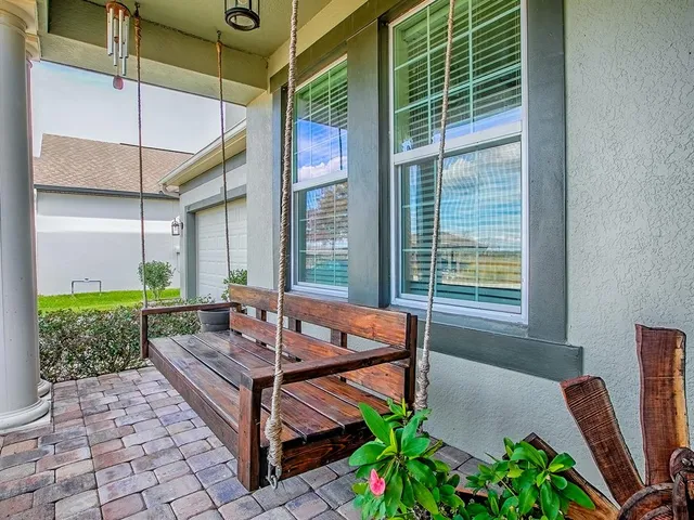 a outdoor space with the couches and dining table with the garden view
