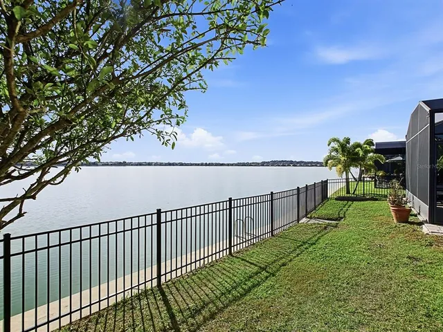 a bathroom with a granite countertop sink and a window
