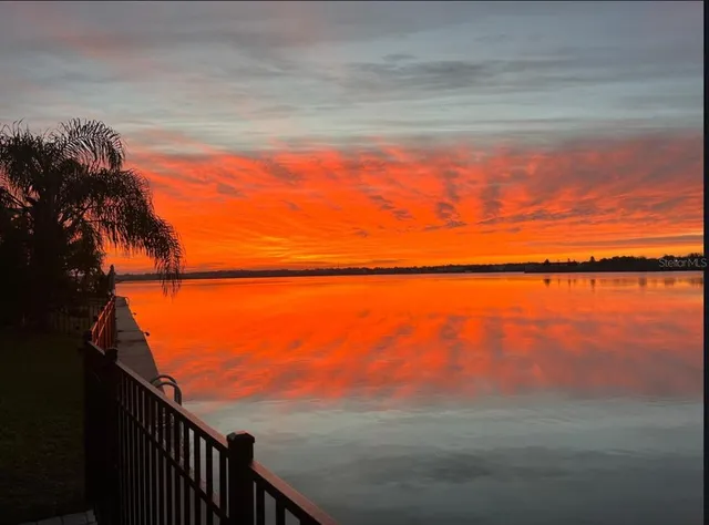 a bathroom with a granite countertop toilet sink and mirror