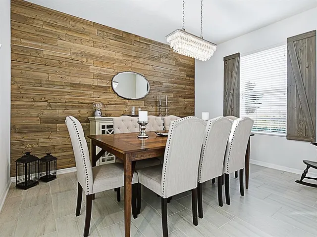 a view of a dining room with furniture and window