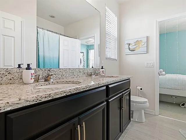 a view of a swimming pool with outdoor seating and plants