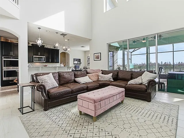 a kitchen with stainless steel appliances kitchen island granite countertop a refrigerator and a stove top oven