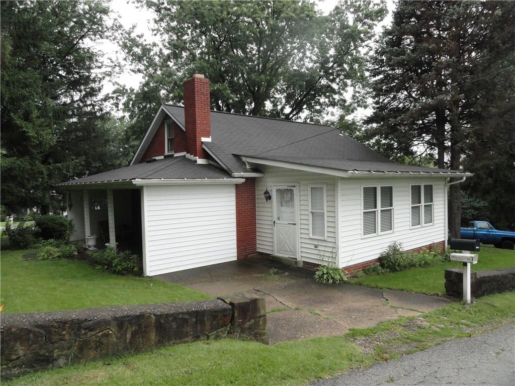 Cute brick and vinyl cape cod on a wooded lot. 